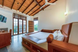 a large bedroom with a large bed and a desk at Nova By Horizon Collection in Unawatuna