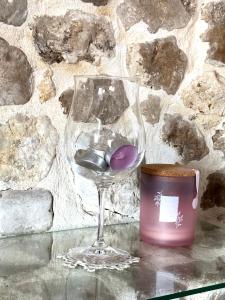 a wine glass with balls in it next to a stone wall at CASA DI Noris in Fiuggi