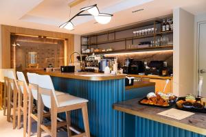 a kitchen with a blue counter and a breakfast bar at Dolce by Wyndham Miami Beach in Miami Beach