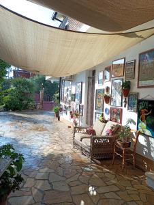 a room with couches and pictures on the wall at B&B Zia Delia in Villaperuccio