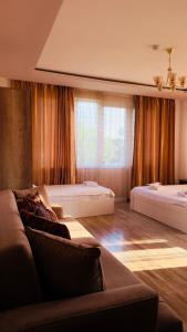 a living room with two beds and a couch at Golden Horizon House in Kobuleti