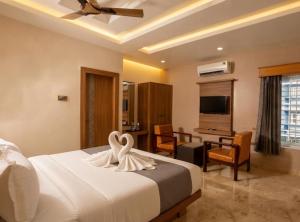 a bedroom with a bed with a swan decoration on it at Taika Hotels, 1km Away from Main Temple in Rāmeswaram