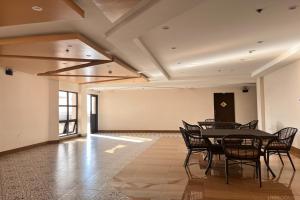 a large room with a table and chairs in it at NSCC Stella Maris Hotel & Convention Center in Cabugao
