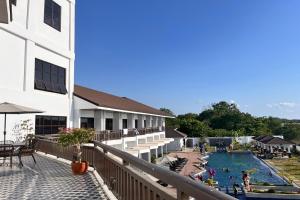 a view of a pool from the balcony of a hotel at NSCC Stella Maris Hotel & Convention Center in Cabugao