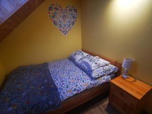 a bedroom with a bed with a heart on the wall at Agroturystyka Od Kaszuba in Żuromino