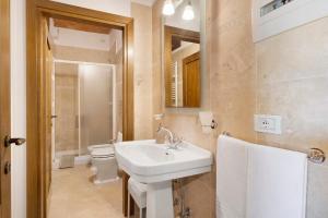 a bathroom with a sink and a toilet and a mirror at Agriturismo Santa Luce in Foiano della Chiana +39 photos