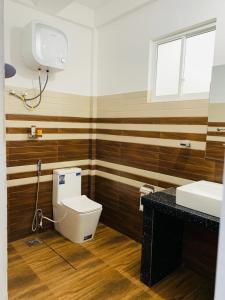 a bathroom with a toilet and a sink at Rawana Mountain View Homestay in Ella +55 photos