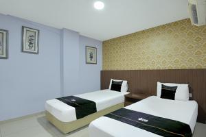 a hotel room with two beds at Dancenter Hotel Shah Alam in Shah Alam