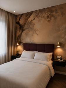 a bedroom with a large bed with a painting on the wall at NEW TOWN Boutique Apartments & Parking in Graz