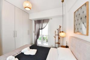 a bedroom with a large bed and a window at Comfy Dots 2 in Larisa