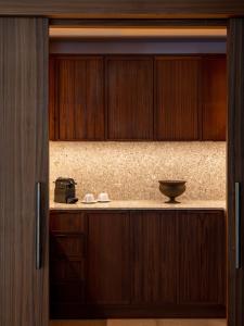a kitchen with wooden cabinets and a bowl on the counter at Keyla Hotel & Beach - Adult Only in Antalya