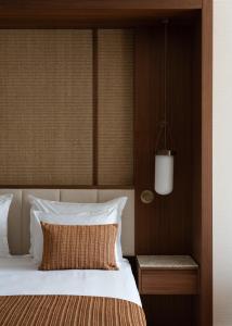 a bedroom with a bed with a wooden headboard at Keyla Hotel & Beach - Adult Only in Antalya +45 photos