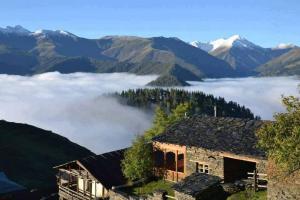 a house in the mountains with a sea of clouds at Telavi ERMA in Telavi