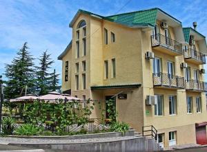 a large yellow building with a green roof at Telavi ERMA in Telavi