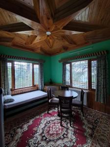 a room with a bed and a table and chairs at Shantiloka - Private 1BHK Homestay in Kulu +30 photos