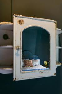 a cabinet with a bed in it with two pillows at Hotel Lola in Cape Town