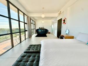 a bedroom with a large bed and a bath tub at Discovery B&B in Linbian