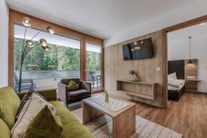 a living room with a couch and a table at Apartment Waldesruh in Oetz