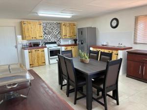 a kitchen with a table and chairs in a room at Kameeldoring Camping & Tented Chalets in Kakamas