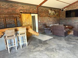 a living room with a couch and a table and chairs at Kameeldoring Camping & Tented Chalets in Kakamas