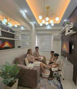 a group of people sitting in a living room at Jade Mantle Sanctuary in Manila