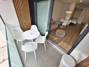 a room with white chairs and a table at BR Silgar Suites in Sanxenxo +187 photos