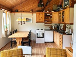 a kitchen with a wooden table and a dining room at 8 person holiday home in Jelsa-By Traum in Jelsa