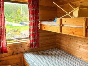 a bedroom with two bunk beds in a log cabin at 8 person holiday home in Jelsa-By Traum in Jelsa