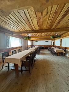 a large room with tables and chairs in it at Noclegi Pod Muńcołem in Ujsoły