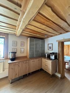 a kitchen with wooden cabinets and a wooden ceiling at Noclegi Pod Muńcołem in Ujsoły