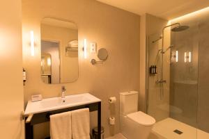a bathroom with a sink and a toilet and a shower at Petit Palace Plaza España in Madrid +27 photos