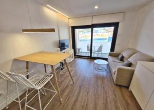a living room with a table and chairs and a couch at BR Silgar Suites in Sanxenxo