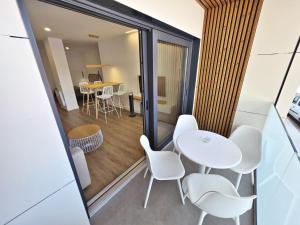 a room with a table and chairs and a dining room at BR Silgar Suites in Sanxenxo