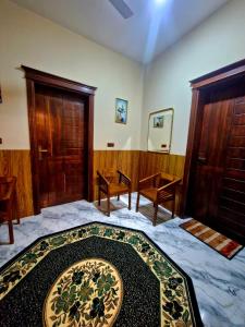 a bedroom with a bed with a rug on it at Town Tulip in Karativu