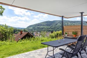 a table and chairs on a patio with a view at Auszeit Helsa in Helsa