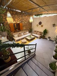 a large living room with couches and potted plants at 5 Min to Beach & Calm Villa Retreat in Safi
