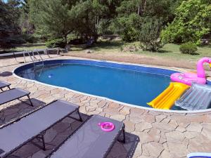 a swimming pool with a plastic flamingo toy in it at Pensjonat Zakątek in Lidzbark