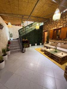 a large patio with couches and potted plants at 5 Min to Beach & Calm Villa Retreat in Safi