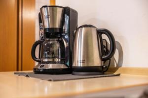 a coffee maker sitting on top of a table at Apartment Gardenview in Kinsau