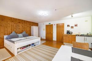 a large bedroom with a bed and a kitchen at Apartment Gardenview in Kinsau +36 photos