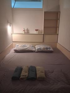 a bed with two blankets and two towels on it at STRUNA in Ohrid