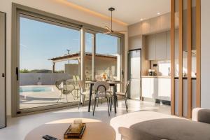 a kitchen and living room with a table and chairs at Villa Esperia in Áyios Síllas