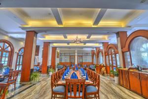 a conference room with a long table with chairs at ORYN-Celebrity Resort, Shamirpet, Hyderabad, Secunderabad, in Shamirpet