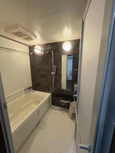 a bathroom with a bath tub and a sink at Hatoya in Mitoyo +26 photos