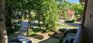 a view of a street with parked cars and trees at Sunrise Apartments 9 in Juodkrantė