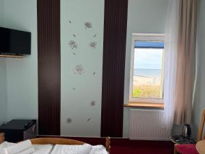 a bedroom with a window with a view of the ocean at Zajazd Dajana in Ustka