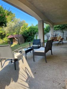 a group of chairs sitting on a patio at Appartement piscine sans vis à vis in Caumont-sur-Durance