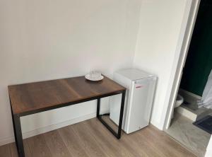a small table and a small refrigerator in a room at aROYAL in Cholpon-Ata