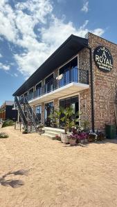a brick building with a balcony on top of it at aROYAL in Cholpon-Ata