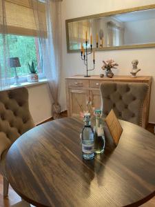 a dining room table with a bottle of water on it at Dorfstübli - gemütliche und ruhige Zimmer in Ortsrandlage in Alt Schönau +24 photos